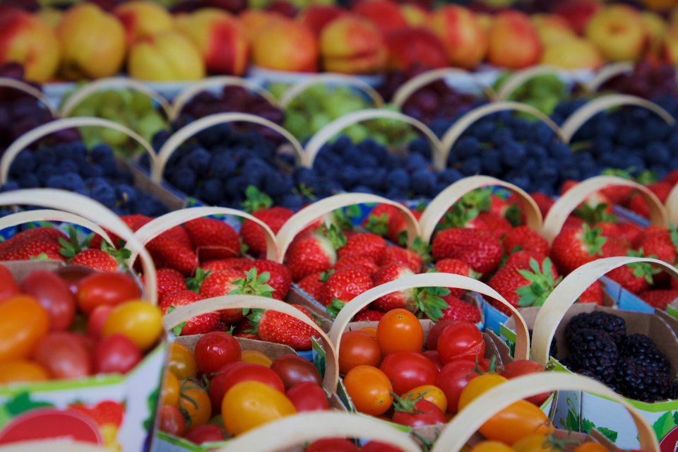 A colorful market display of fresh fruit and berries
